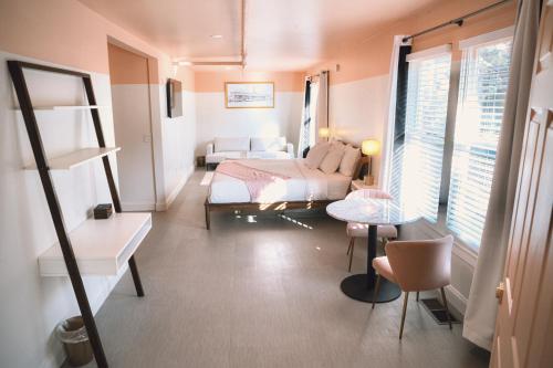 a bedroom with a bed and a couch and a table at Peninsula Bed & Cocktails in St Petersburg
