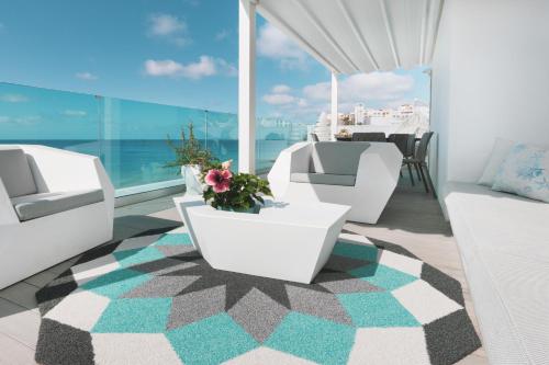 a balcony with white furniture and a view of the ocean at RichMood Apartments - PARADISE Apartment in Morro del Jable