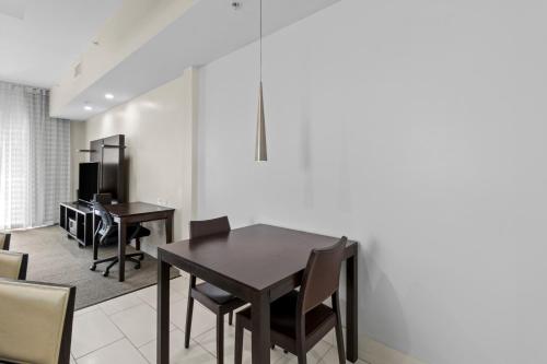 a dining room with a table and chairs at Provident Doral At The Blue in Miami