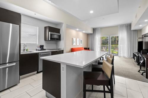 a kitchen with a large white island in a room at Provident Doral At The Blue in Miami