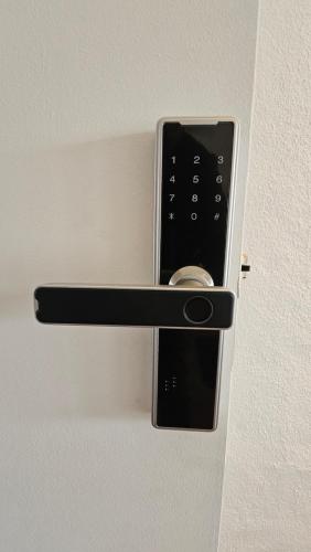 a remote control sticking out of a wall at CARCAROOMS Guest House in Carcavelos