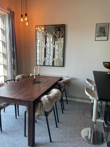 a dining room with a wooden table and chairs at 3 room Apartment in country in Helsinge
