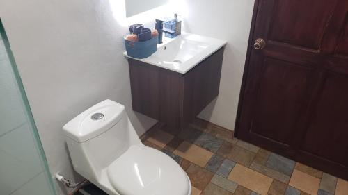a bathroom with a white toilet and a sink at Casa tipica in Fortuna