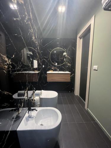 a black and white bathroom with a sink and a toilet at PRIMO RE, Luxury Rooms in Campobasso