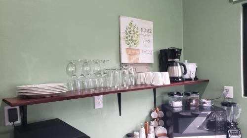 a shelf with glasses and plates on it in a kitchen at Casa tipica in Fortuna