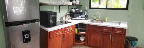 a small kitchen with a sink and a refrigerator at Casa tipica in Fortuna