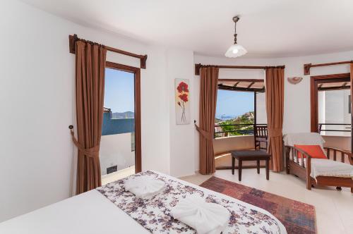 a bedroom with two beds and a balcony at Villa Erel in Kas