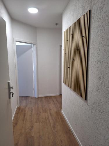 an empty room with a hallway with a door at Ferienwohnung auf dem Pferdehof am Gestütsweg in Alt Krenzlin
