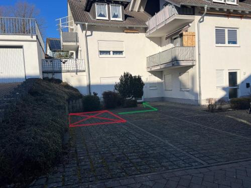 a red line on a driveway in front of a building at APARTMENT in Altendiez in Altendiez