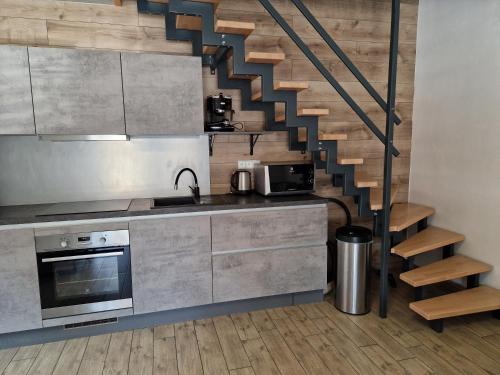 a kitchen with a spiral staircase in the middle at Relax Vila Lipno 2 u pláže Windy Point in Černá v Pošumaví