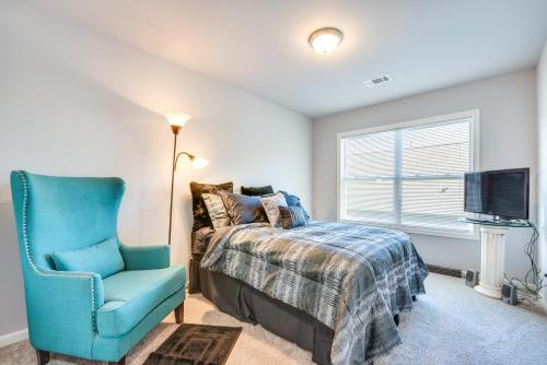 a bedroom with a bed and a chair and a television at Atlanta Home with Patio, 8 Mi to Downtown and Aquarium in Atlanta