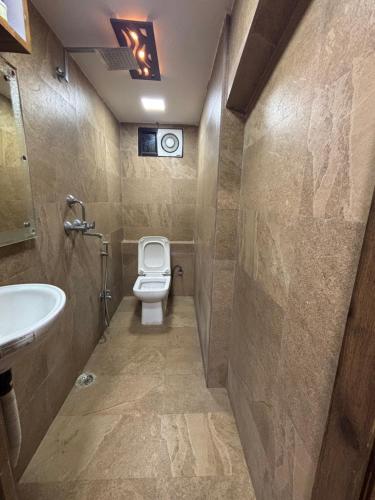 a bathroom with a toilet and a sink at Gupta Residence. in Dhanbād
