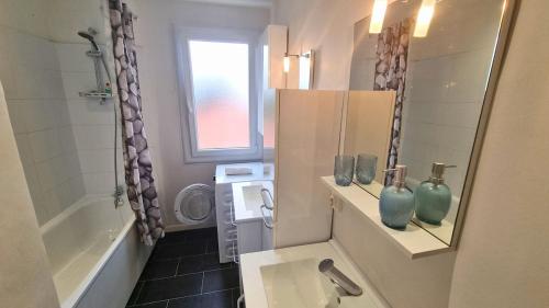 une salle de bain avec un lavabo et des toilettes et une fenêtre dans l'établissement Le Duplex Pyrénéen - Terrasse - Clim - Parking, à Lons