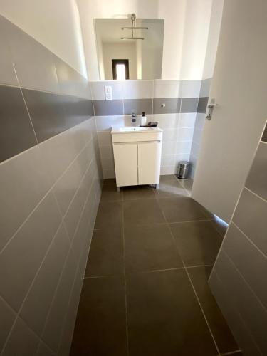 a bathroom with a sink and a mirror at Maison Cieurac in Cieurac