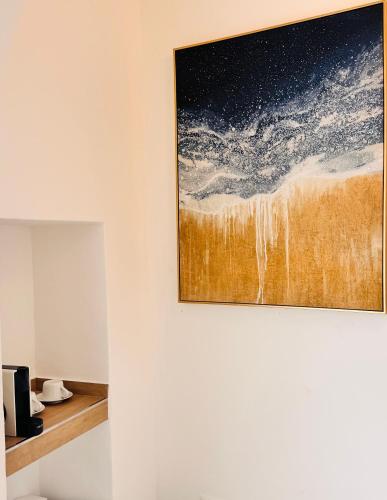 a painting hanging on a wall in a room at La Ripa Camere Vernazza - La Medusa Studio in Vernazza