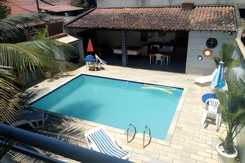 a swimming pool in front of a house at Casa em Iguaba Grande - RJ (Região dos Lagos) (1) in Iguaba Grande