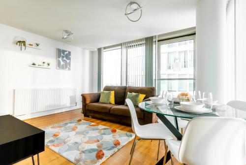 a living room with a table and a couch at Luxury Two Bed City Apartment -The Hub in Milton Keynes