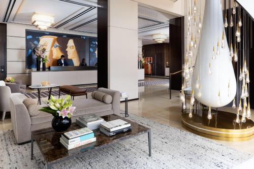 a living room with a couch and a table at The Langham, New York, Fifth Avenue in New York