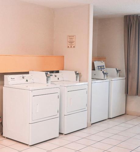a room with white washers and dryers in a room at Quality Inn Colorado Springs Airport in Colorado Springs
