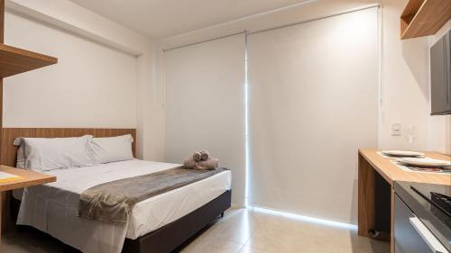 a bedroom with a bed with a teddy bear on it at By DH: Luxo e conforto em Perdizes, aos poucos minutos do Allianz parque in Sao Paulo