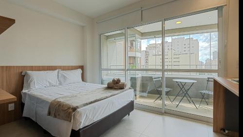 a bedroom with a bed with a teddy bear on it at By DH: Luxo e conforto em Perdizes, aos poucos minutos do Allianz parque in Sao Paulo