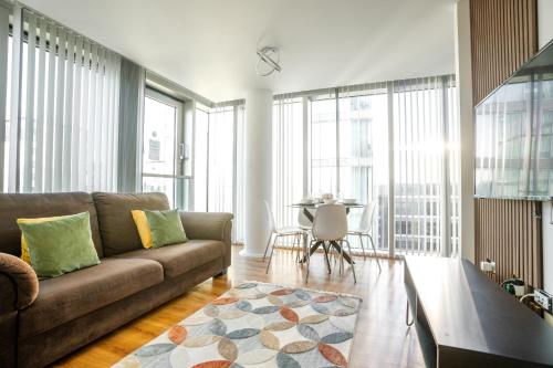 a living room with a couch and a table at Luxury Two Bed City Apartment -The Hub in Milton Keynes