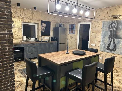 a kitchen with a table and chairs in a room at Forest house for family in Lebeniškiai