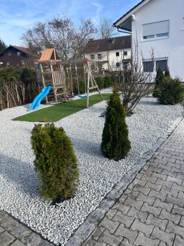 a playground with a slide in a yard at Appartementshaus Vlora in Bad Füssing