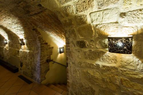 a light fixture on a stone wall in a tunnel at Hotel Theophano in Quedlinburg
