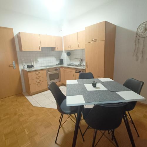 a kitchen with a table and chairs in a room at TauberNest in Bad Mergentheim
