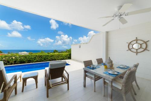 a dining room with a view of the ocean at 17 Westmoreland Hills in Saint James