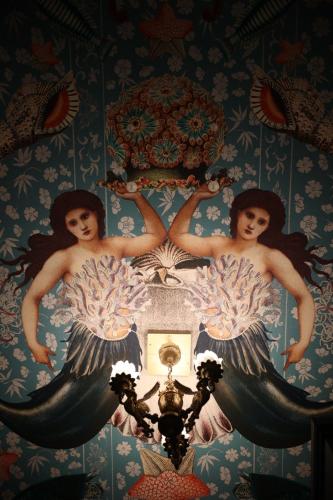 a painting of two mermaids on a wall at The Harrison Chambers of Distinction in Belfast