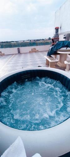 a hot tub on top of a building at Appartement entier avec Terasse, Hammam, BBQ in Alger