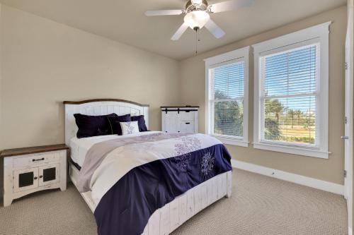 a bedroom with a bed and a ceiling fan at Mannanan Mac Lir in Galveston