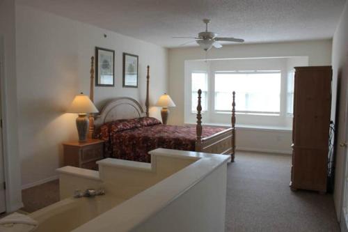 a bedroom with a bed and a window at Four Seasons Luxury condo on the Lake in Lake Ozark
