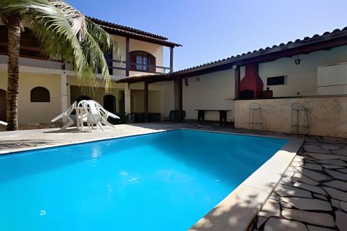 einem Pool vor einem Haus mit einer Krabbenstatue in der Unterkunft Linda casa em Porto da Aldeia (Cabo Frio) - RJ in São Pedro da Aldeia