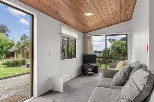 a living room with a couch and a tv at Bethshan Motel in Algies Bay