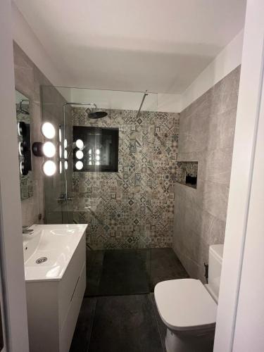 a bathroom with a sink and a toilet at Casa Picacho in Tinajo