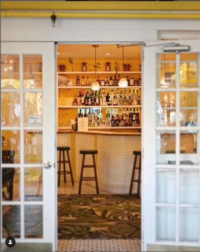 an open door into a bar with stools at Peninsula Bed & Cocktails in St Petersburg