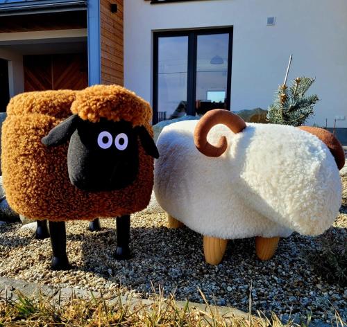 two stuffed sheep standing next to each other at Domki Szczyt Beztroski - Balia & Sauna in Nowy Targ