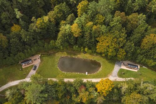 an aerial view of a park with cars and a pond at Thistle House at Camp Greenwood Vermont with Sauna in Chester