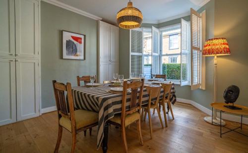 a dining room with a table and chairs at Stylish Home with 4 bedrooms, Logburner, Garden, nr Beach, Deal Castle in Deal
