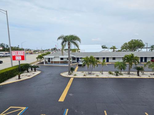 a parking lot with a no parking sign in front of a building at Deluxe Inn - Sarasota in Sarasota