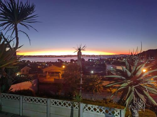a view of a city at night with palm trees at MayBach Hills Palace Guesthouse in Saldanha