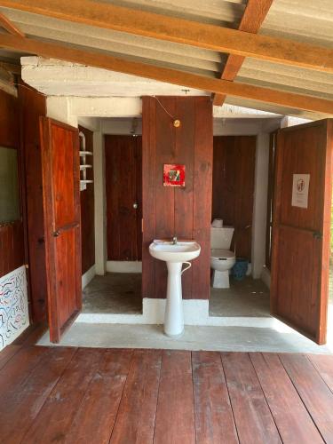a bathroom with a toilet and a sink at Shanti Lanka Ashram in Guayabas