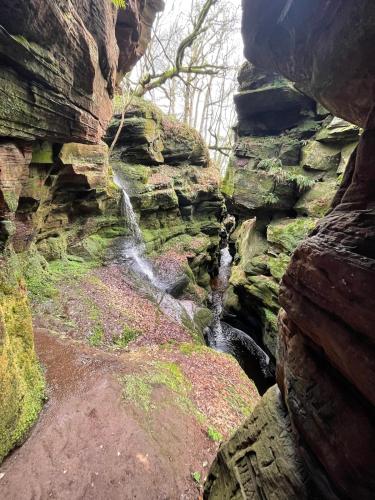 a waterfall on the side of a rocky cliff at Oakbank near Thornhill in Thornhill
