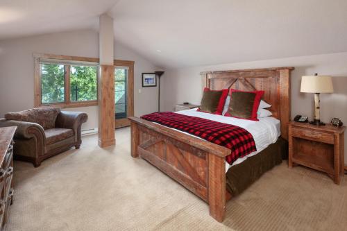 a bedroom with a large bed and a chair at Lodge at Whitefish Lake in Whitefish