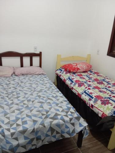 two beds sitting next to each other in a room at Casa na praia do cassino in Rio Grande