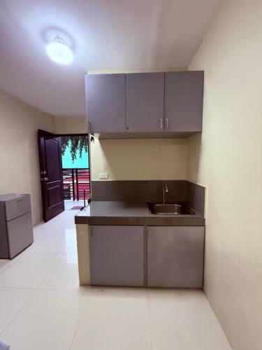 a kitchen with gray cabinets and a sink at Dau homesite mabalacat pampanga in Mabalacat
