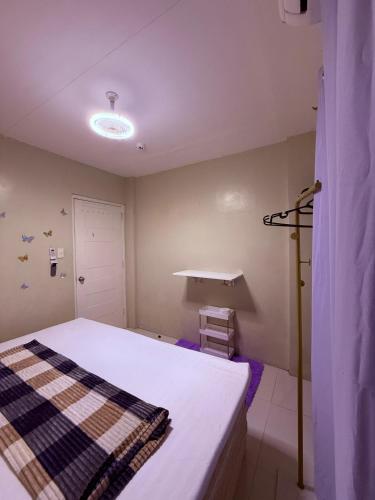 a small room with a bed and a light at Dau homesite mabalacat pampanga in Mabalacat